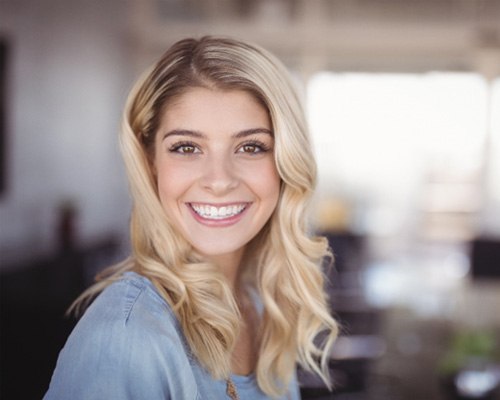 Patient smiling after getting a dental bridge in Tustin