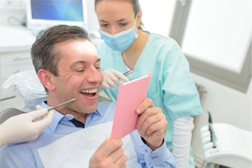 Patient smiling after getting a dental bridge in Tustin