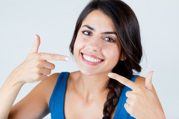 Patient smiling after getting dental bridge in Tustin