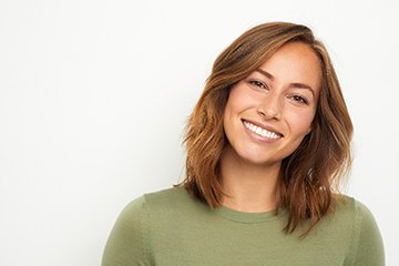 woman smiling after getting dental crowns in Tustin