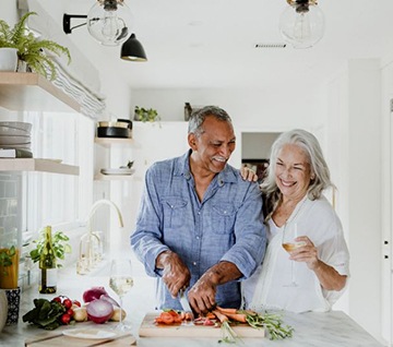 Happy senior couple preparing meal together