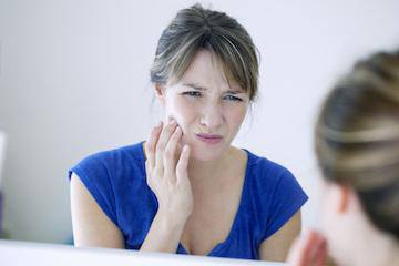 Woman in pain before emergency dentistry