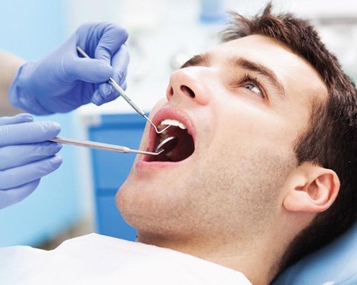 Dentistry patient receiving dental exam and teeth cleaning