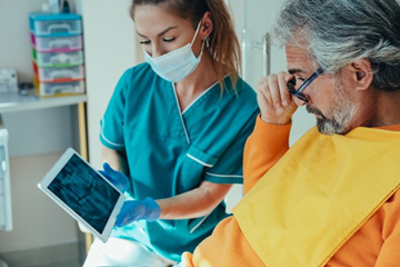 Dentist showing a concerned patient his X-ray