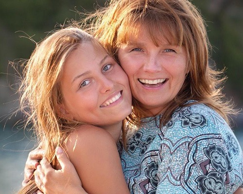 Mother and daughter with tooth colored fillings smiling