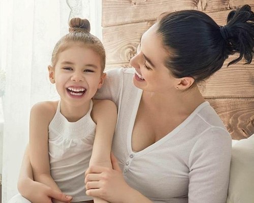 Mother and daughter smiling together after general dentistry visit