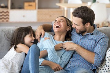 Family laughing together after general dentistry visit
