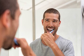 Patient in Tustin brushing teeth carefully 