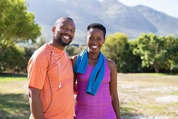 Couple smiling after tooth replacement with dental implants