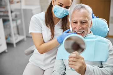 man smiling after getting dental implants in Tustin 