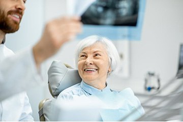 a patient smiling at her dentist during her visit