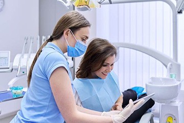 A patient paying the cost of Invisalign in Tustin