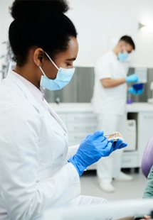 A dentist near SANTA ANA explaining how dentures work to a patient