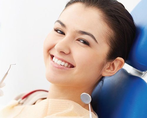 Young woman smiling after root canal therapy