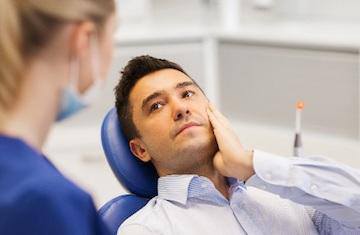 Man with tooth pain before root canal therapy