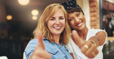 Two women smiling after cosmetic dentistry