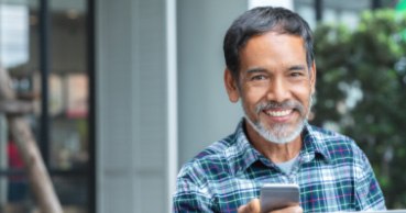 Smiling older man with dental crown supported fixed bridge