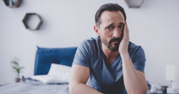 Man holding his cheek with tooth pain before root canal therapy