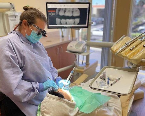 Dental team member using advanced dental technology