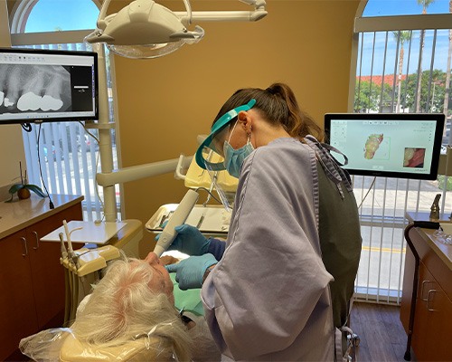 Dental team member using advanced dental technology