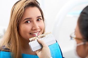 Woman smiling during consultation for veneers in Tustin