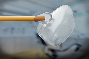 Veneers being held to an applicator