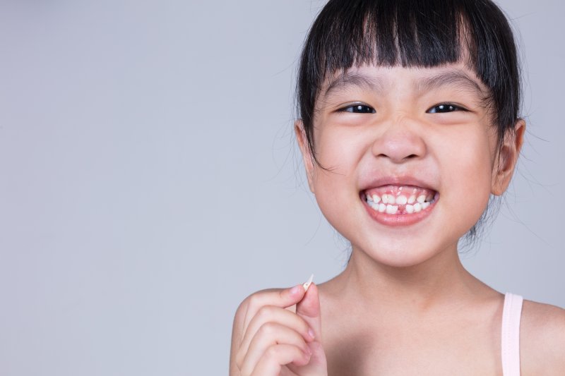 A child smiling after getting a dental filling