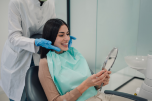 a patient admiring their teeth in a mirror